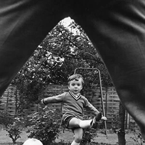 Aston Villa footballer Ron Wylie playing football with his son Nigel in the garden of