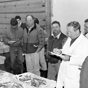 Auctioneer Arthur THomas conducting business at Brixham fishmarket in the 1980s