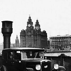 An Austin motor car crossing the River Mersey on a luggage boat in Liverpool