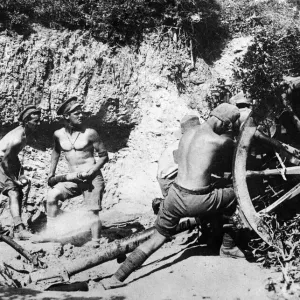 Australian gunners of the 9th Field Battery stripped to the waist operating the Number 4 Australian gunners of the 9th Field Battery stripped to the waist operating the Number 4