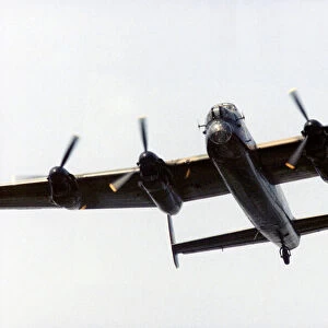 An Avro Lancaster bomber in flight over Littleton Road playing fields, Manchester