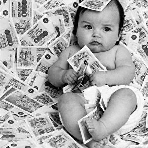 Baby Diane from Glasgow, Scotland, surrounded by bank notes from Clydesdale Bank Limited