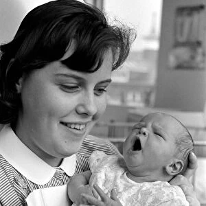 Baby girl in the arms of a nurse at a childrens hospital in Liverpool