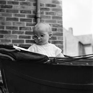 Baby wearing glasses. June 1952 C3211