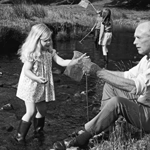 Bagging a brace of tiddlers with his grand daughter Clare is Sir Alec Douglas Home