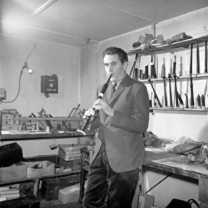 Bagpipe maker Mr. George Alexander seen here in his workshop. Circa 1960