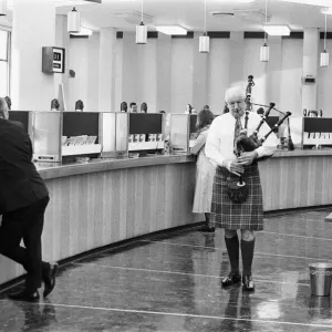 A bagpiper pipes the last day of business of 1970 in the Lloyds banking hall