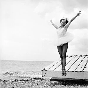 Ballerina Anne Youngmen seen here in a tutu practising her dance moves beside the sea