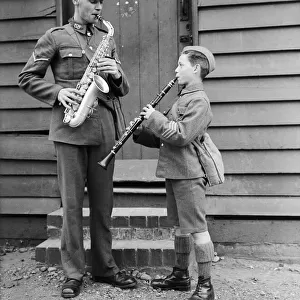 A bandsman of the South Staffordshire Regiment seen here rehearsing with a boy soldier at