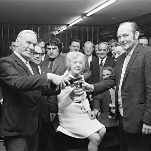 Barmaid retires in Billingham, enjoying a celebration drink with customers, 1973
