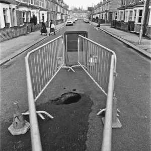 Barriers erected around a large hole in Norfolk Road, Reading, which suddenly appeared Barriers erected around a large hole in Norfolk Road, Reading, which suddenly appeared