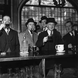 Barristers, clerks and newsmen from a neighbouring office gather together at the Feathers