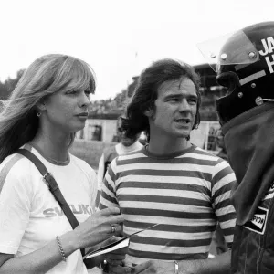 Barry Sheene and his girlfriend Stephanie McLean talking to James Hunt at a practice day