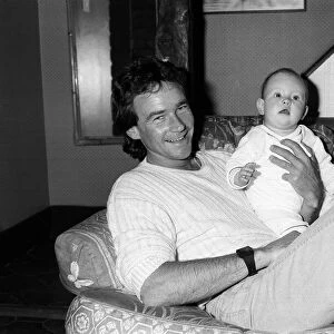 Barry Sheene at home with baby daughter Sidonie, May 1985