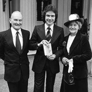 Barry Sheene with his mother and father and MBE, March 1978