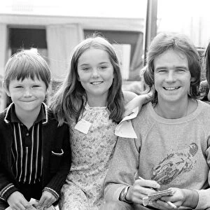 Barry Sheene signs autographs for three young children who broke through the security to