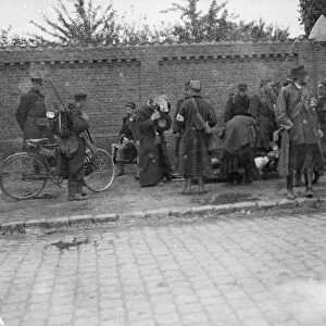 Battle of Hofstade. Priests attended to an injured soldier as a cycle patrol set out