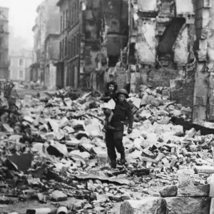 Print of a British soldier carrying a little girl through the ruins of Caen