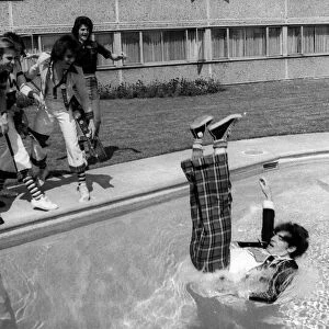 Bay City Rollers guitarist Alan Longmuir is thrown into the swimming pool by other band