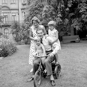 BBC Announcer Alexander McIntosh seen here at home with his wife and children. Circa 1957