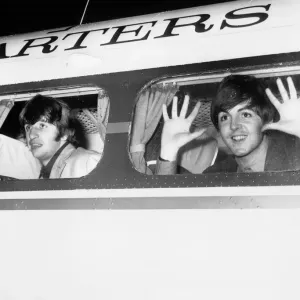 Beatle members Ringo Starr (left) and Paul McCartney look out of the window of plane Beatle members Ringo Starr (left) and Paul McCartney look out of the window of plane