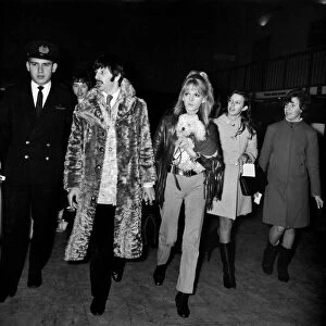 Beatles drummer Ringo Starr and his wife Maureen with their pet poodle at Heathrow
