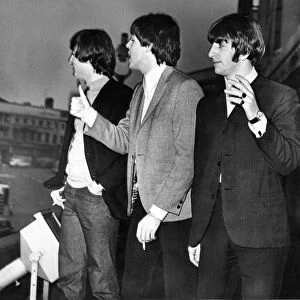 The Beatles enjoy a cigarette break on the balcony of the Empire Theatre in Liverpool 8th