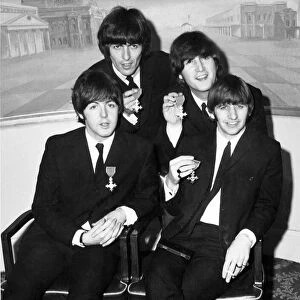 The Beatles holding their MBE s. (Members of the British Empire