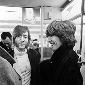 Beatles John Lennon and George Harrison at Heathrow Airport before departing to India
