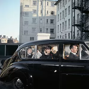 The Beatles John Lennon and Ringo Starr can be seen in the back of a black limosine being