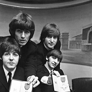 The Beatles show off their MBE medals after the royal investiture at Buckingham Palace