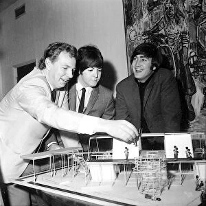 Beatles Paul McCartney (centre) and John Lennon are shown the stage set of a new show