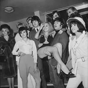 Beatles Paul McCartney and John Lennon with showgirls before rehearsals for