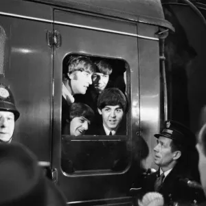 The Beatles peer from a train carriage window at Paddington Station, London The Beatles peer from a train carriage window at Paddington Station, London
