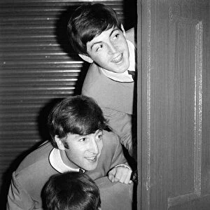 The Beatles peering out from behind a door. before the groups appearence at Sunday Night