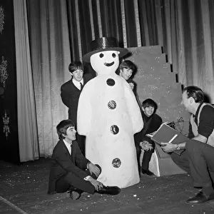 The Beatles pose with a Snowman, as they take a break from rehearsals at the Astoria