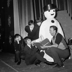 The Beatles pose with a Snowman, as they take a break from rehearsals at the Astoria