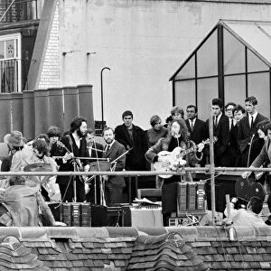 Beatles on the rooftop of their Apple headquarters in London Saville Row giving their