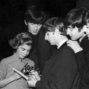 The Beatles sign autographs for a young fan after concert at the Odeon in Southend-on-Sea