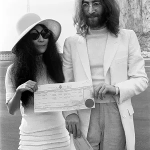 Beatles singer John Lennon and his new bride Yoko Ono holding their marriage certificate Beatles singer John Lennon and his new bride Yoko Ono holding their marriage certificate