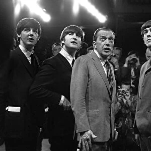 The Beatles with television host Ed Sullivan during their appearance on the Ed Sullivan