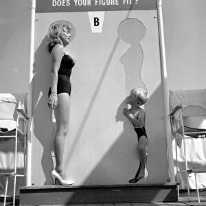 Beauty contest girl at Sandbank seen here with her younger rival. 14th July 1959