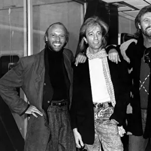 The Bee Gees Pop Group leaving Heathrow for Paris. Robin Gibb flanked by his two