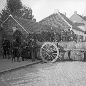 Belgian soldiers man a barriacde made of barrels in Zele following the fall of Brussels