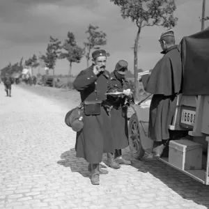 Belgian soldiers marching up to the front seen here passing hastily written letters to a