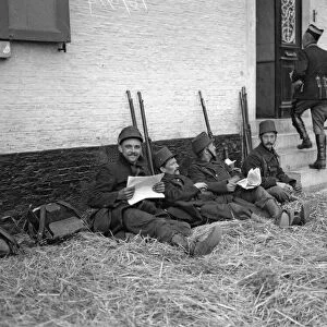 Belgian soldiers seen here resting and catching up with the news at Diest
