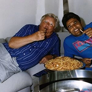 Benny Hill Actor Comedian With Fellow Actor Erik Estrada Eating A Plate Of Chips
