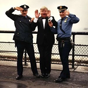 Benny Hill actor and comedian is hancuffed in a send up of the TV Programme "