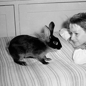 Bernard Alfieri Jnr. Boy with his pet rabbit on his bed. 20th July 1934
