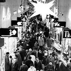 Under the Bethlehem star shoppers stream along the City Arcade in Coventry